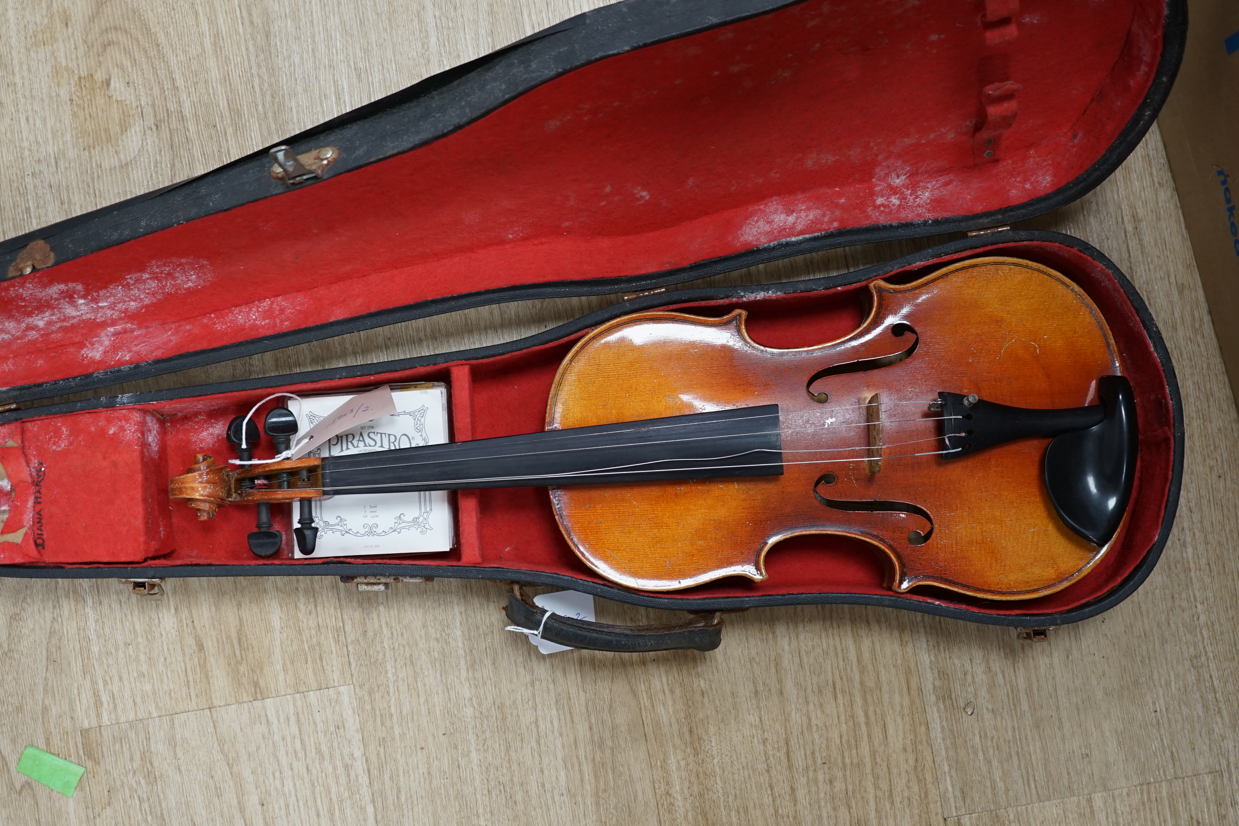 A cased Czechoslovakian student’s violin with Stradivarius label, length of body, 35.5cm, with spare strings